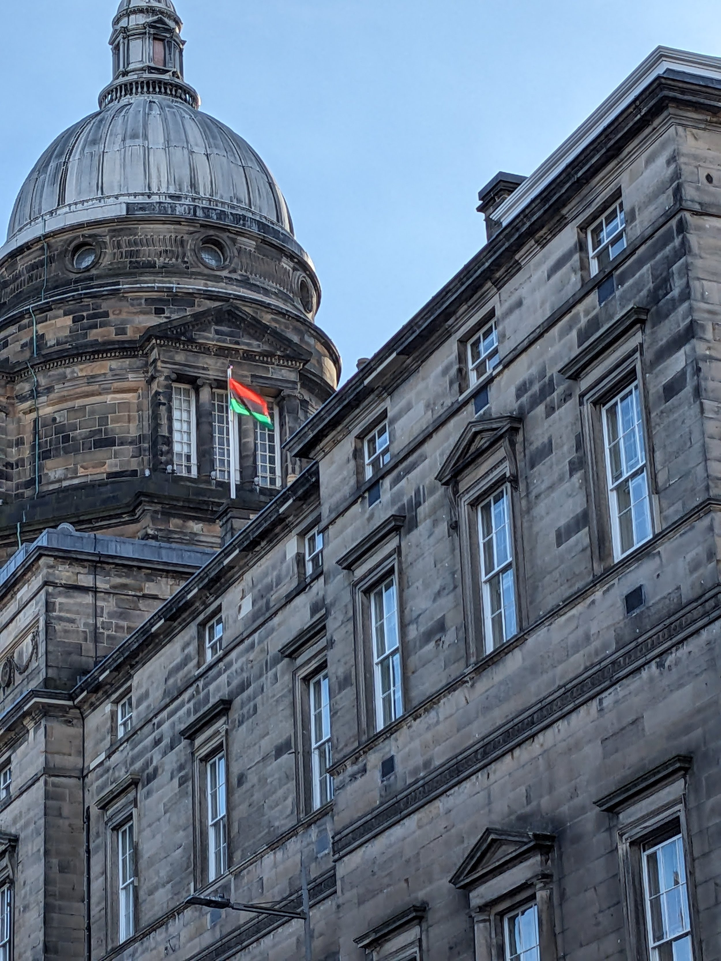 Image of University Old College dome with a Palestinian flag